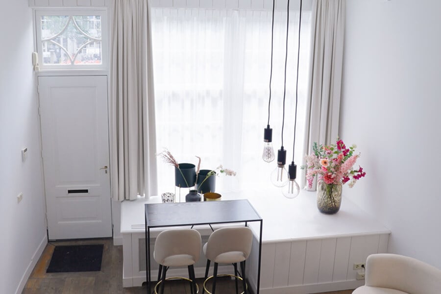 Lichte entree met lichte overgordijnen in combinatie met voile